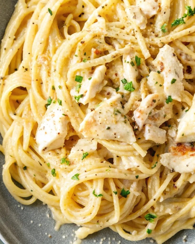 Creamy lobster pasta with spaghetti served in a decorative blue and white bowl