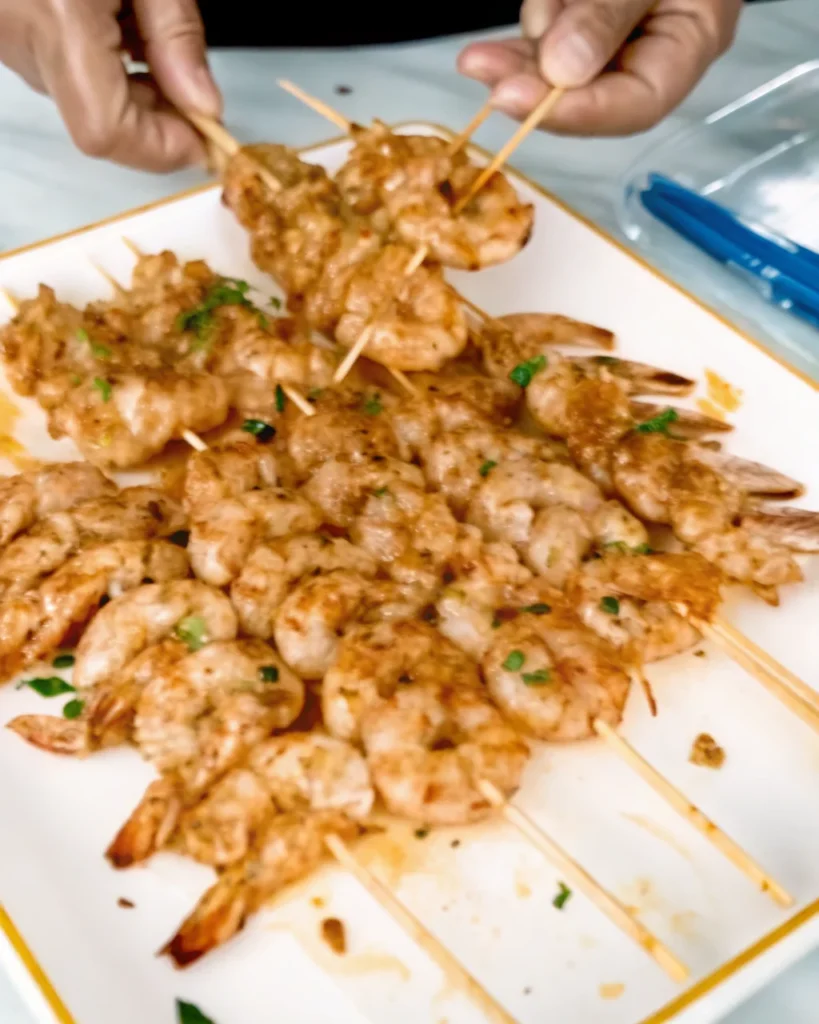 Easy Mediterranean Shrimp Kabobs served on skewers with fresh herbs and grilled to perfection.