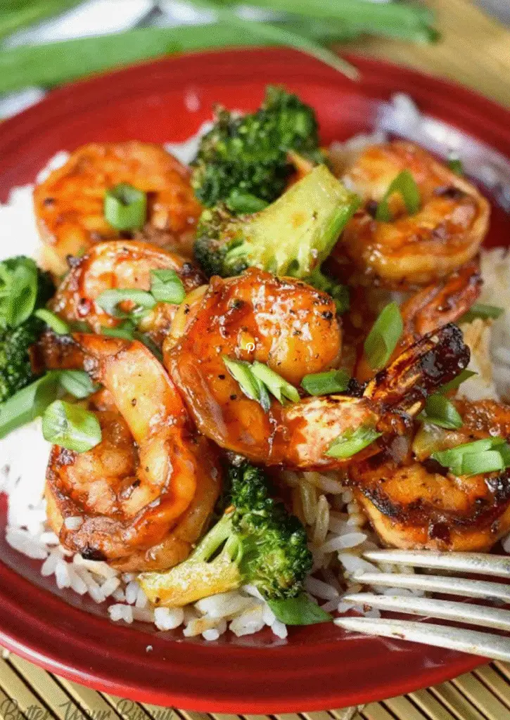 Honey garlic butter shrimp with broccoli in a skillet, garnished with a golden glaze and seared to perfection.