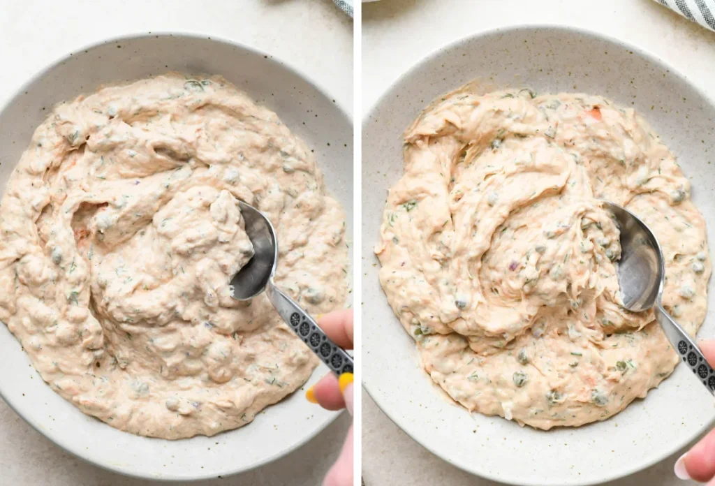 Creamy salmon spread with fresh dill garnish served in terracotta bowl alongside crackers