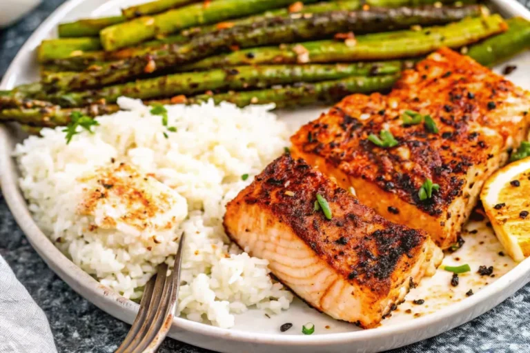 Cajun honey butter salmon fillets seared in cast iron skillet with golden glaze and fresh parsley garnish