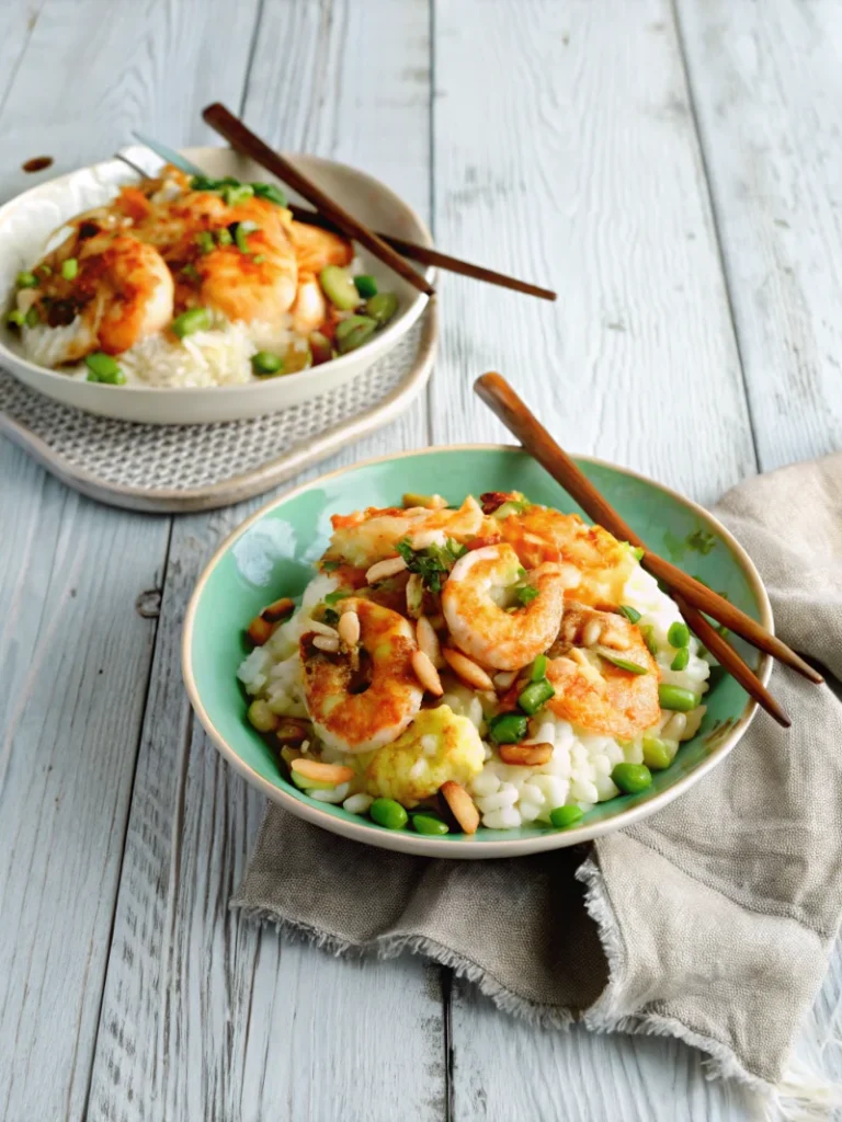 Two bowls of shrimp and grits topped with bacon, mushrooms, and green onions on a rustic wooden table.