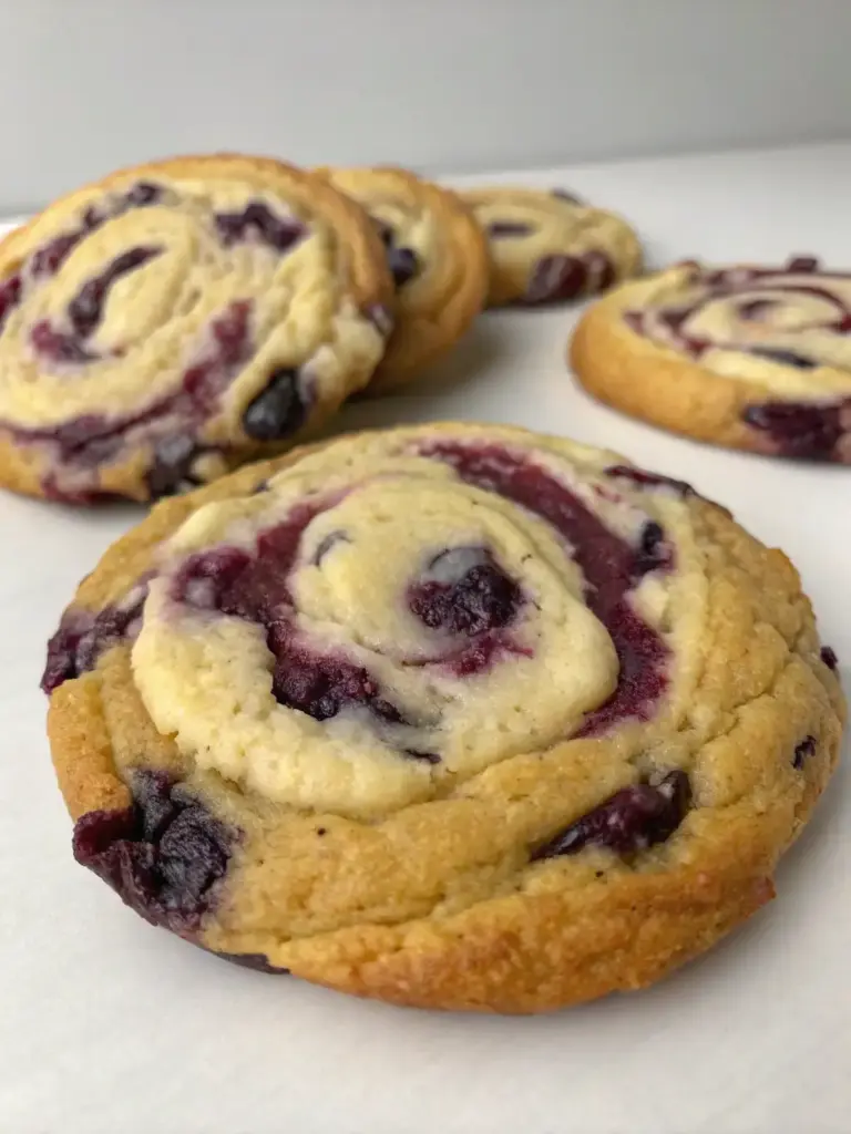 A delicious plate of Blueberry Cheesecake Swirl Cookie